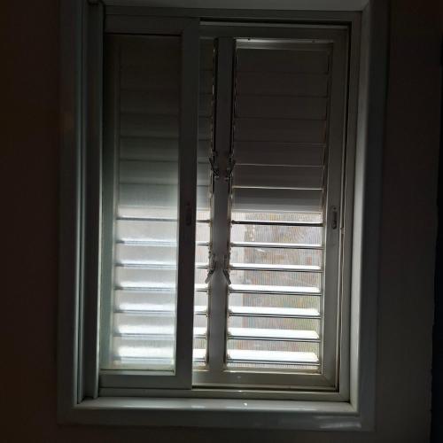 a window in a room with blinds at Maggie's home in Tel Aviv