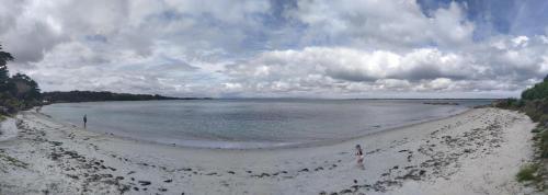 a view of a sandy beach with the ocean at Seascape Peninsula Bach in Kaitaia