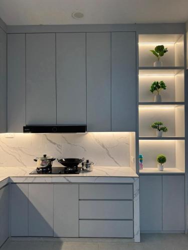 a kitchen with white cabinets and a stove at Monde Residence Block K number 17 in Bagam