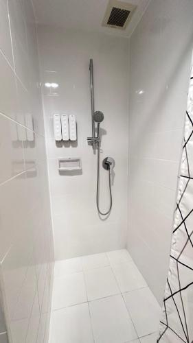 a white bathroom with a shower and a toilet at Indy2 Bangna km7 By koii in Bang Kew Yai