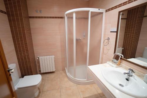 a bathroom with a shower and a toilet and a sink at Hotel Rural L'Antic Portal in Vilafames