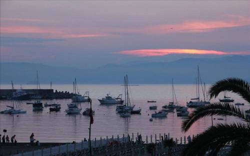 a group of boats docked in a harbor at sunset at B&B Portobello in Sestri Levante