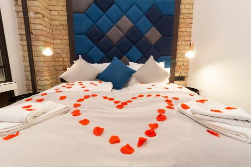 a bed with a heart made out of red flowers at The Loft Budapest in Budapest