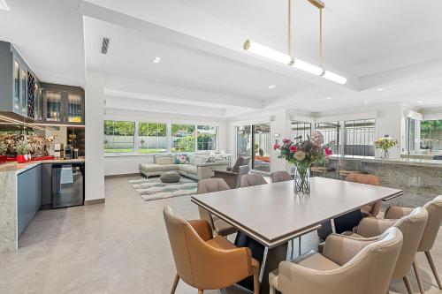 a kitchen and living room with a table and chairs at Exquisite Oasis Family Retreat in Perth