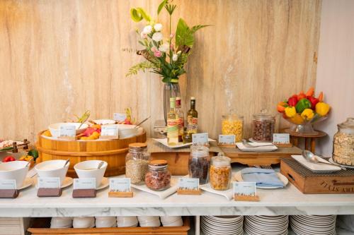 a table with food on it with bowls and plates at The Briza Beach Resort, Khao Lak SHA Extra Plus in Khao Lak