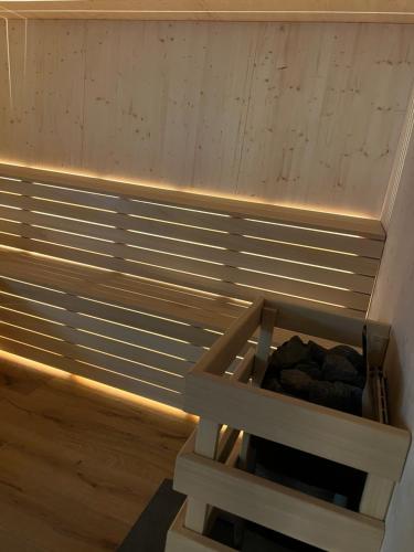 a sauna with a wooden crate filled with rocks at Mountain Resort in Rangersdorf