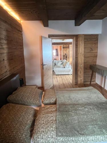 a bedroom with two beds and a couch in the background at Mountain Resort in Rangersdorf