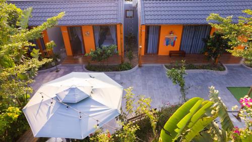a white umbrella sitting in front of a house at Rosa Garden in Ninh Binh