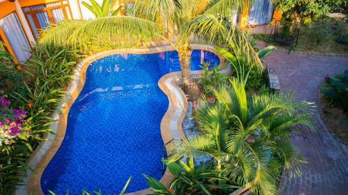 an overhead view of a swimming pool with palm trees at Rosa Garden in Ninh Binh