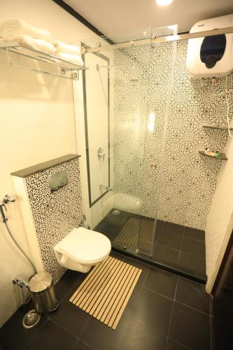 a bathroom with a shower and a toilet in it at Harnawa Haveli - A Boutique Heritage Stay in Jaipur