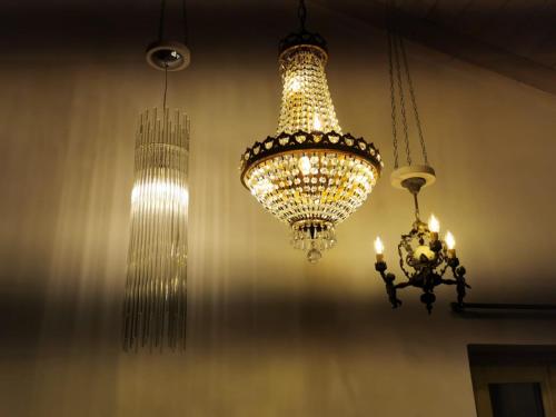 two chandeliers are hanging from the ceiling at Magic Mola in Zeri