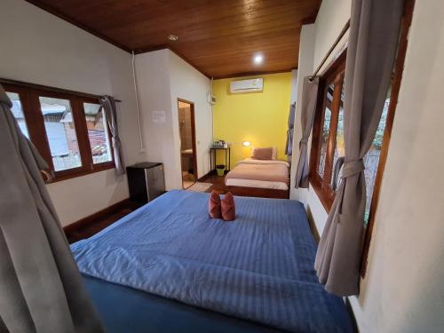 a bedroom with a bed with shoes on it at Sleep Pai Bed & Breakfast in Pai