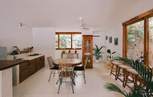 a kitchen and dining room with a table and chairs at Marlaca Villas Lombok in Kuta Lombok