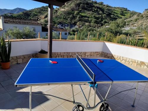 a blue ping pong table on a patio at Casa La Fuente in El Chorro