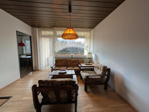 a living room with a couch and a table at Beach Apartement direkt am Ossiacher See in Tschöran
