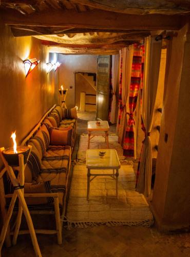 a living room with a couch and a table at Riad Hmam Sofa in Taroudant