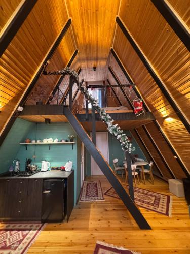 an attic kitchen with a staircase in a house at Cottage Sataplia in Kutaisi