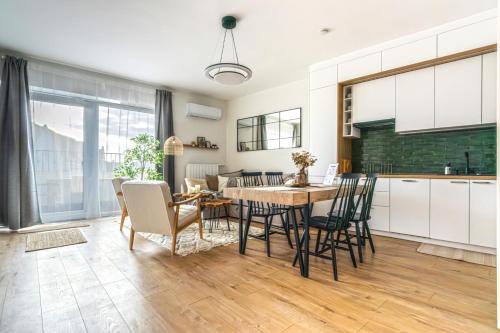 a kitchen and dining room with a table and chairs at Buda Top Floor Apartment with Terrace & View in Budapest