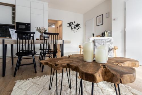 a living room with a wooden table with candles on it at Buda Top Floor Apartment with Terrace & View in Budapest