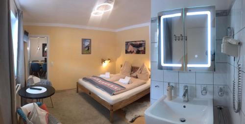 a bedroom with a bed with a sink and a mirror at Landhaus Josefa in Flachau