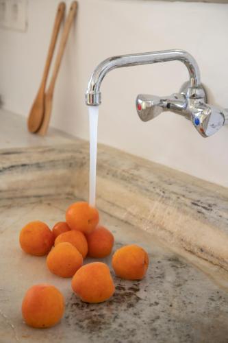 a bunch of oranges are under a water fountain at K-Homes Superior double in Tinos