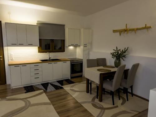 a kitchen and dining room with a table and chairs at PS Apartment Polydrosos - PS Rental in Polydrossos