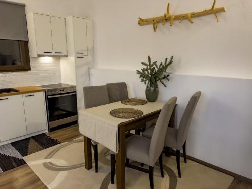 a kitchen with a table with chairs and a vase on it at PS Apartment Polydrosos - PS Rental in Polydrossos