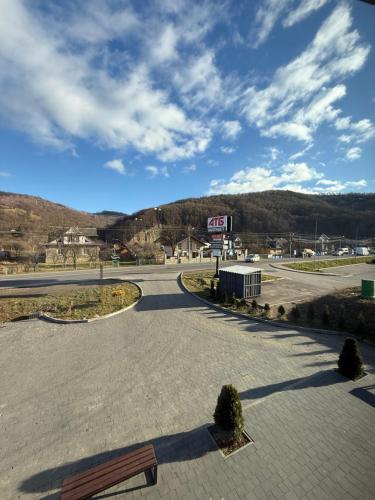 an empty parking lot with a gas station in the distance at Cottage Gutsulia in Yaremche