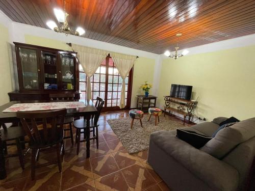 a living room with a couch and a table at Recanto da Araucária 2 in Campos do Jordão
