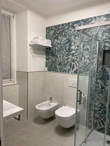 a bathroom with a shower and a toilet and a sink at Bed and Breakfast Sweet Home in Tirano