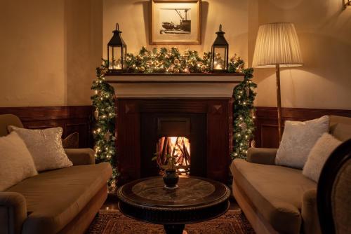 a living room with a fireplace with christmas decorations at The Grand Hotel - Heritage Grand in Nuwara Eliya