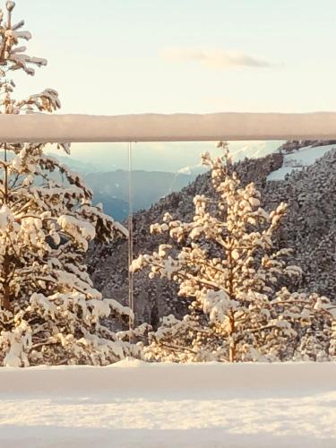 a window with a view of a snow covered mountain at Chalet Tschattlhof Dolomites in Ponte Nova