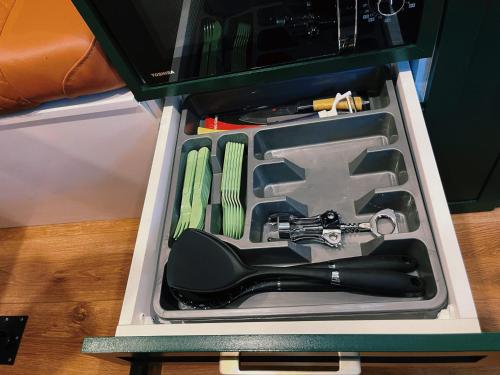 a drawer with a gun and utensils in it at Huckleberry - Fully equipped camper van in Kutaisi, Georgia in Kutaisi