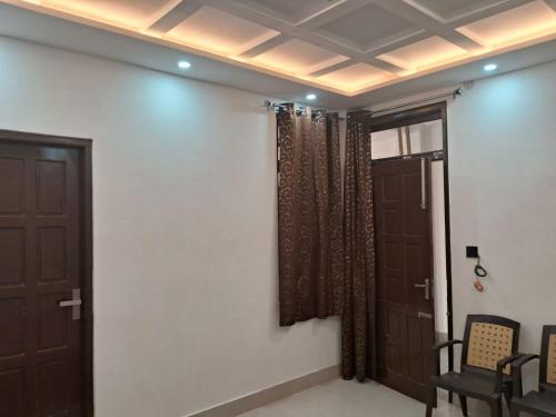 a room with two brown doors and a window at Bholenath Homestay Dalhousie in Dalhousie