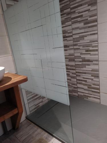 a shower with glass doors in a bathroom at Gîtes Les Grandes Voies - Clé Vacances in Le Ménil