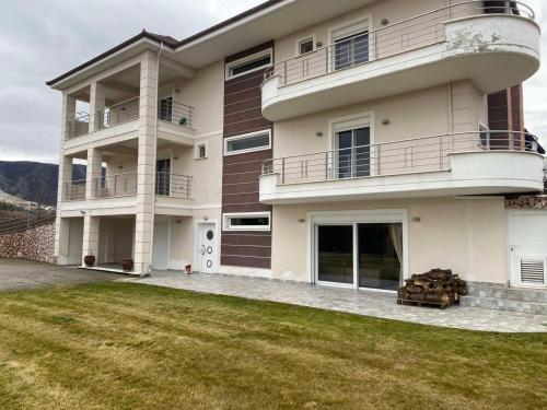 a large building with a lawn in front of it at Luxury Heaven farm one in Kastoria