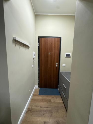 a hallway with a wooden door in a room at Il Rifugio in Piazza in Castel di Sangro
