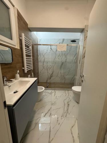 a bathroom with a sink and a toilet and a shower at Il Rifugio in Piazza in Castel di Sangro