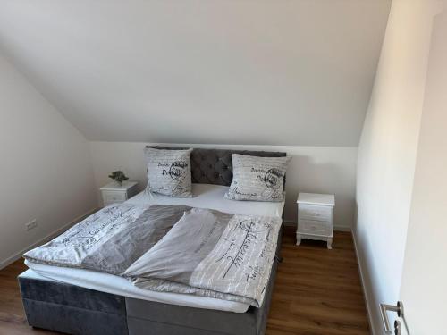 a bedroom with a large bed with white sheets and pillows at Pension Romantica in Rust