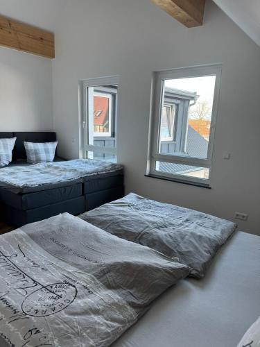 a bedroom with two beds and a mirror on the wall at Pension Romantica in Rust