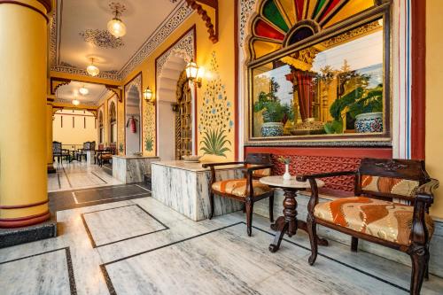 a lobby with chairs and paintings on the wall at Umaid Residency - A Regal Heritage Home in Jaipur