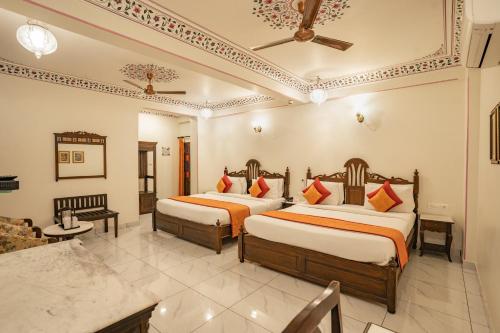 a hotel room with two beds in a room at Umaid Residency - A Regal Heritage Home in Jaipur