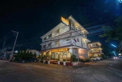 a building with a sign on the side of it at Nuntiya Terrace in Udon Thani