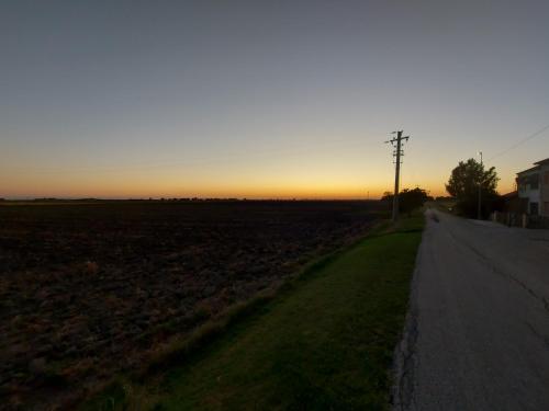 a road leading to a field at sunset at Relax Rurale in Fienile Nuovo Malea