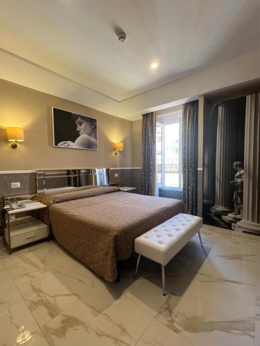 a bedroom with a bed and a tv on the wall at Hotel Garda in Rome