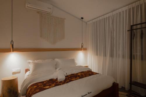a bedroom with a large bed with white sheets and pillows at Armenian House by IIP in George Town
