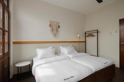 a bedroom with a large bed with white sheets at Armenian House by IIP in George Town