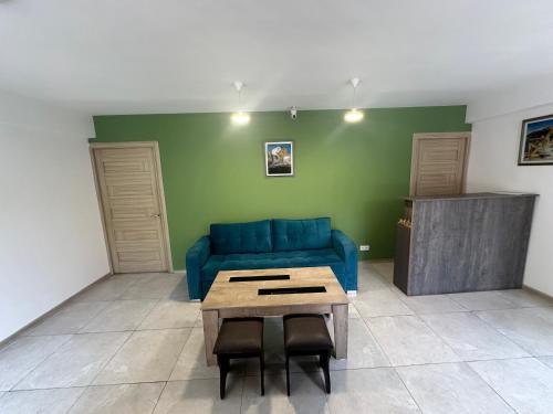 a living room with a blue couch and a table at Best Hostel in Yerevan