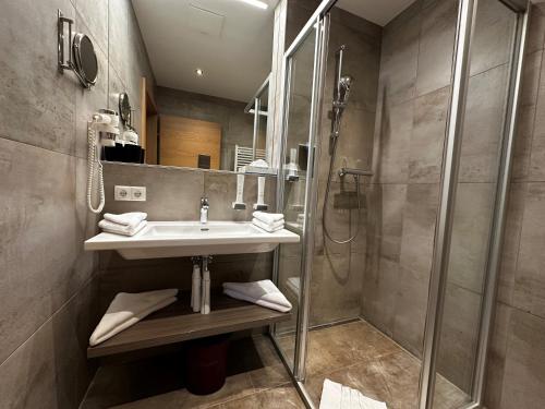 a bathroom with a sink and a shower at Der Burgfellnerhof - Adults Only in Schladming