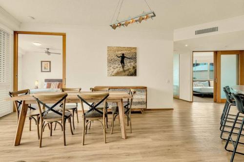 a dining room with a table and chairs at Waves 203 on Currumbin in Gold Coast